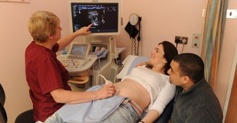 Nurse carrying out ultrasound with couple