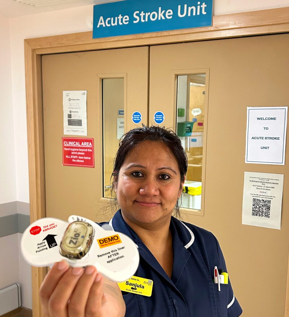 Sanjula Dhungana outside the Acute Stroke Unit, holding holding one of the new Zio XT devices in its packaging before it is fitted.
