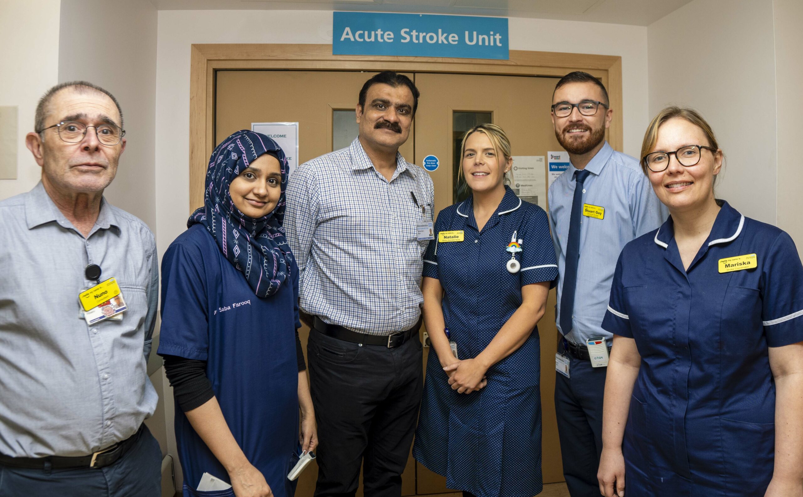 Members of the Stroke Unit team at Worcestershire Royal Hospital stood outside the Acute Stroke Unit entrance.
