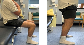 A person sitting down and standing up without using their arms.