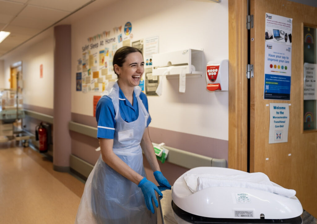 A nurse in uniform on a ward round