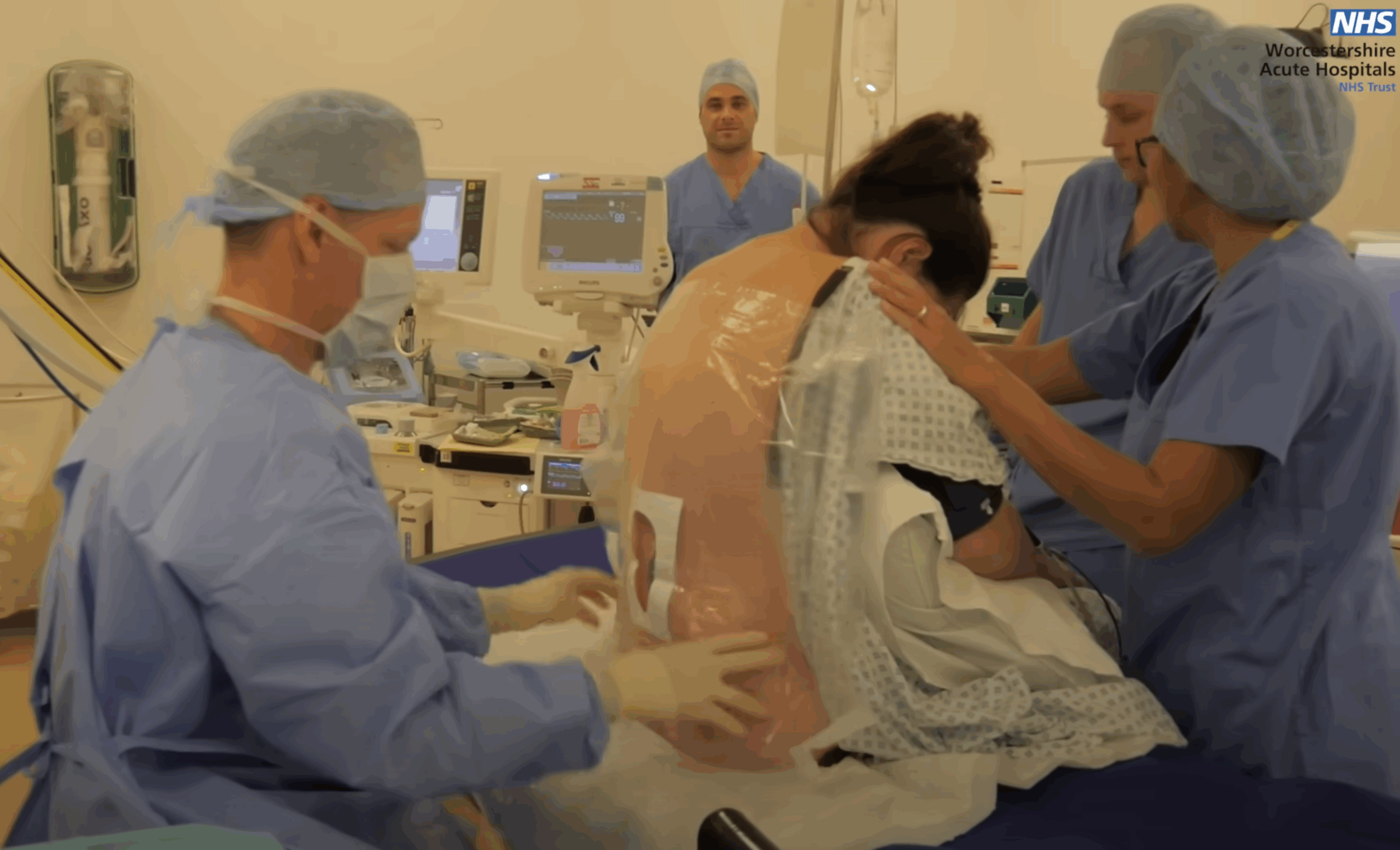 An anaesthetist performing an epidural on a woman at Worcestershire Royal Hospital.