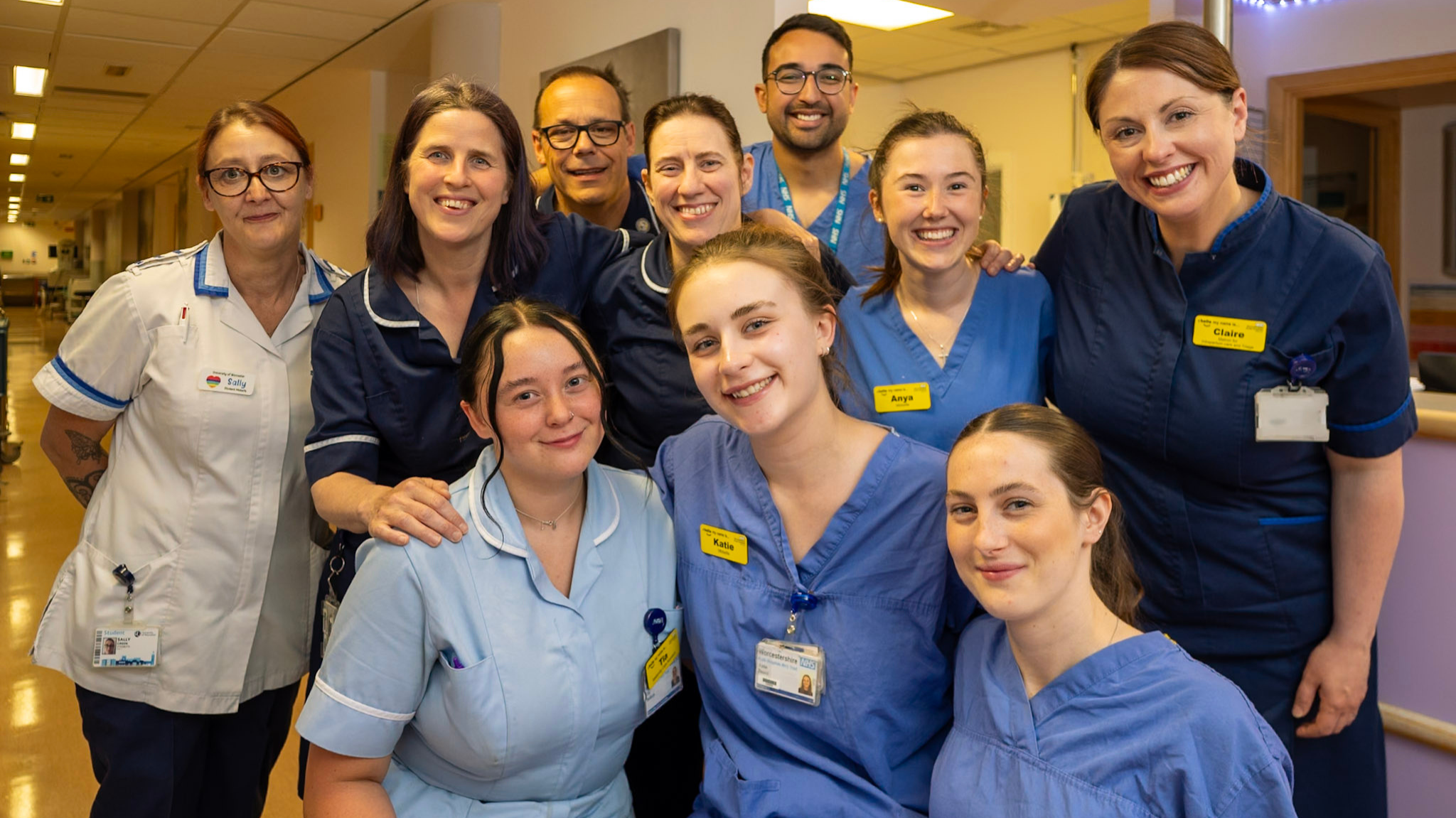 A group photo of the team of midwives and staff from the Delivery Suite smiling in hospital.