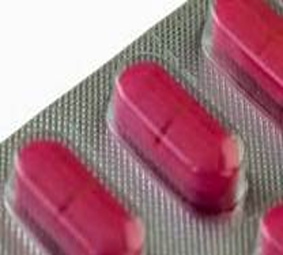 A photograph of red coloured tablets in a blister