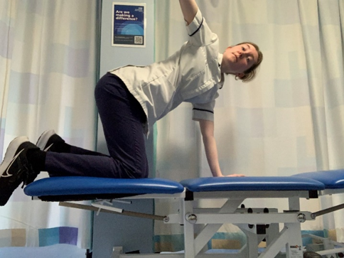 A person on hands and knees on the bed. Reverse the movement and reach up and back towards the ceiling.