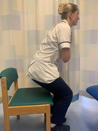 A picture of the person leaning the body forwards to look at toes.