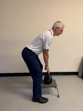 A picture of a person from a side view demonstrating the deadlift.